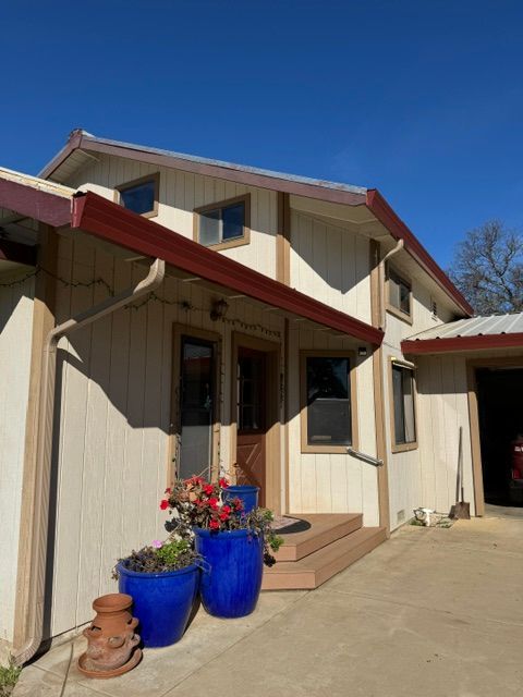 A house with blue potted plants in front of it