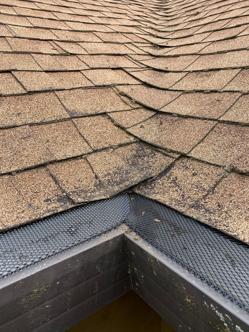 A close up of a roof with a gutter on it.