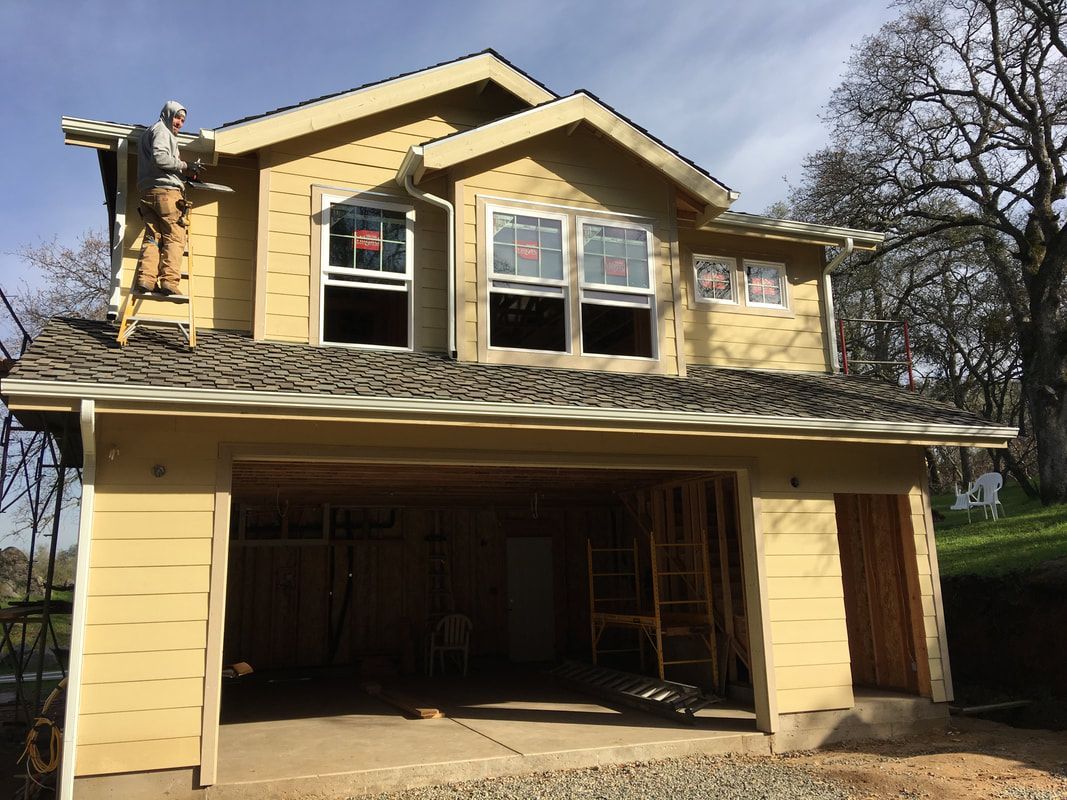 The roof of a house with a wooden roof and a black gutter.