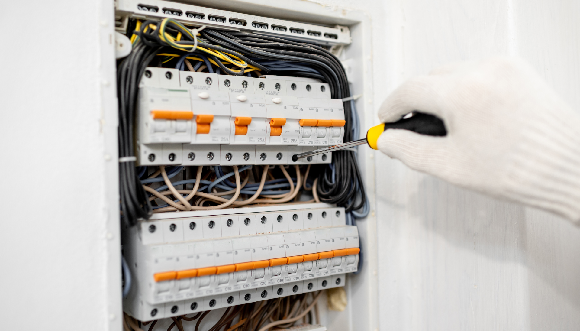 A man is giving a thumbs up while working on an air conditioner.