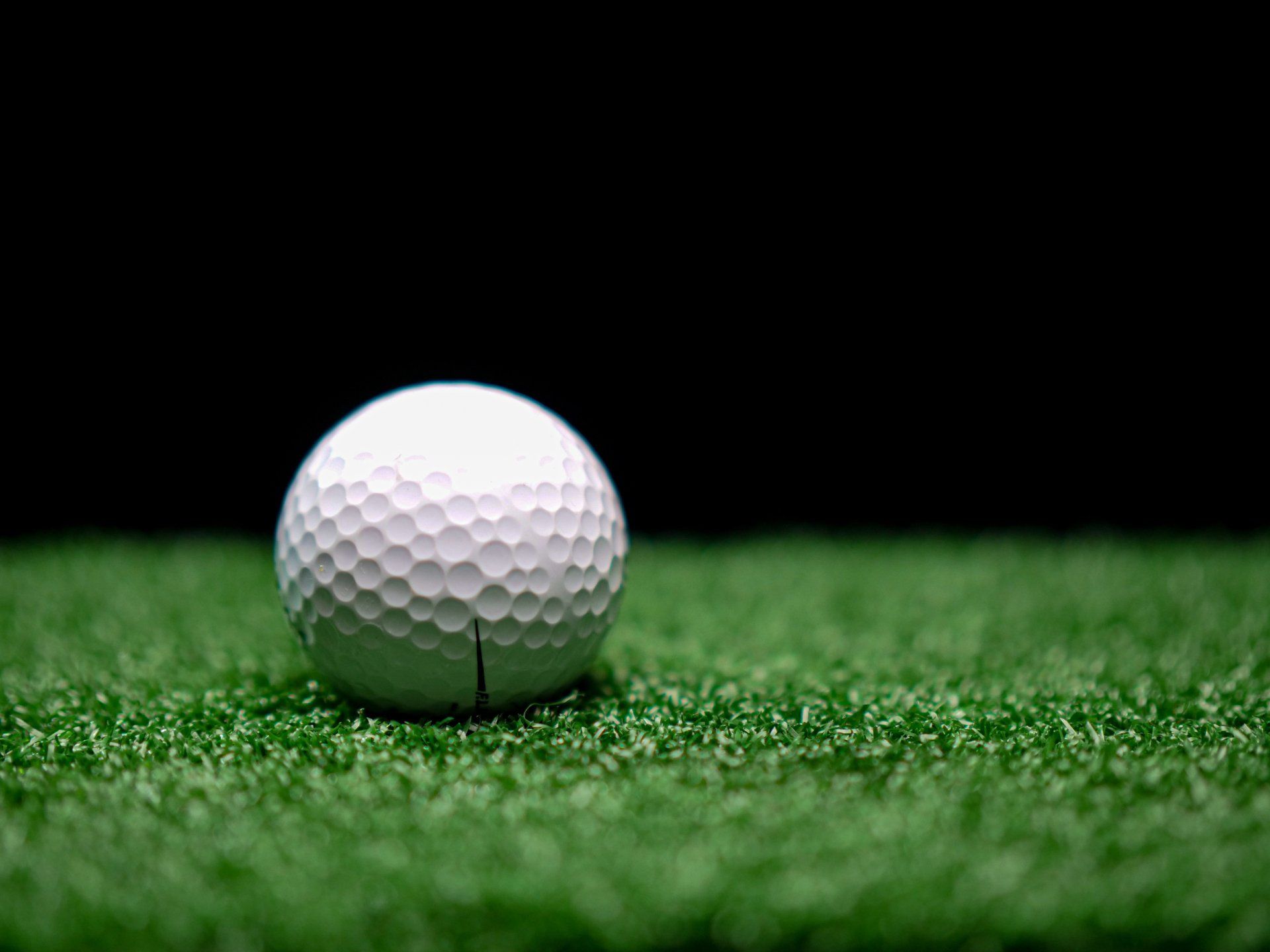 golf ball laying on the artificial turf putting green in Apache Junction AZ