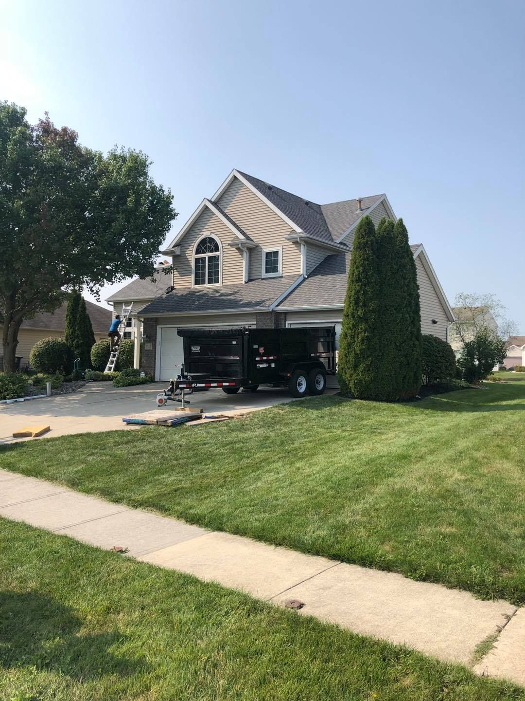 A house with a black truck parked in front of it.