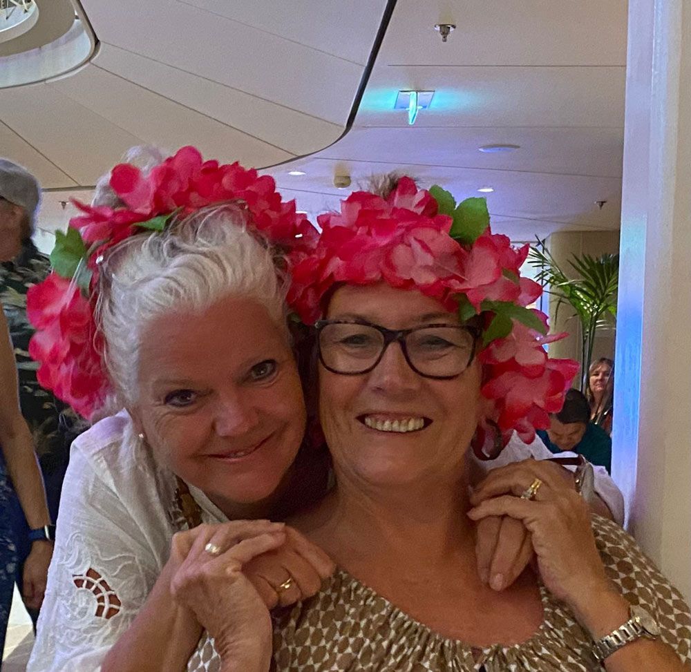Two Ladies with Pink Flowers In Their Hair — Pink Up Gold Coast in Southport, QLD