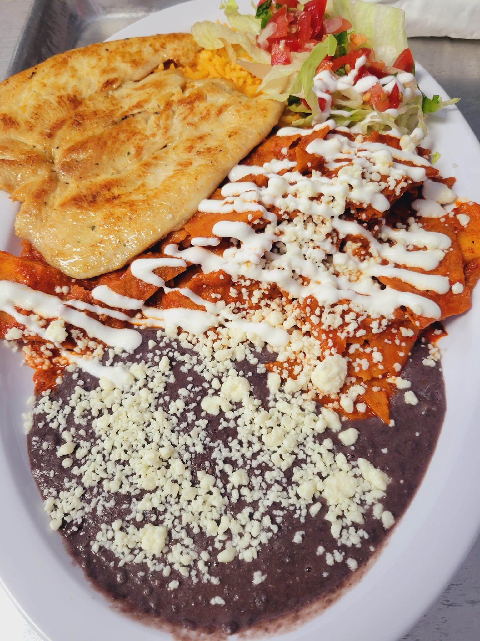 A plate of food with beans and cheese on it