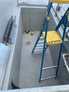 A blue ladder with a yellow seat that says barley