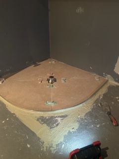 A shower stall is being installed in a bathroom.