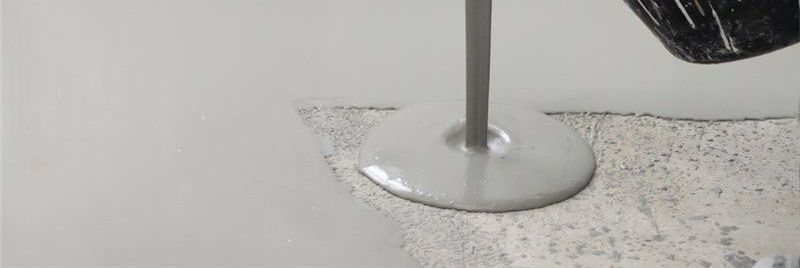 A person is using a drill to cut a hole in a wall.