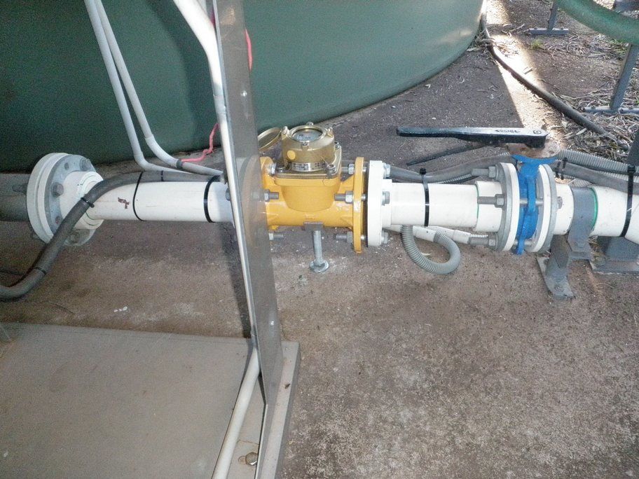 A white pipe with a yellow valve attached to it