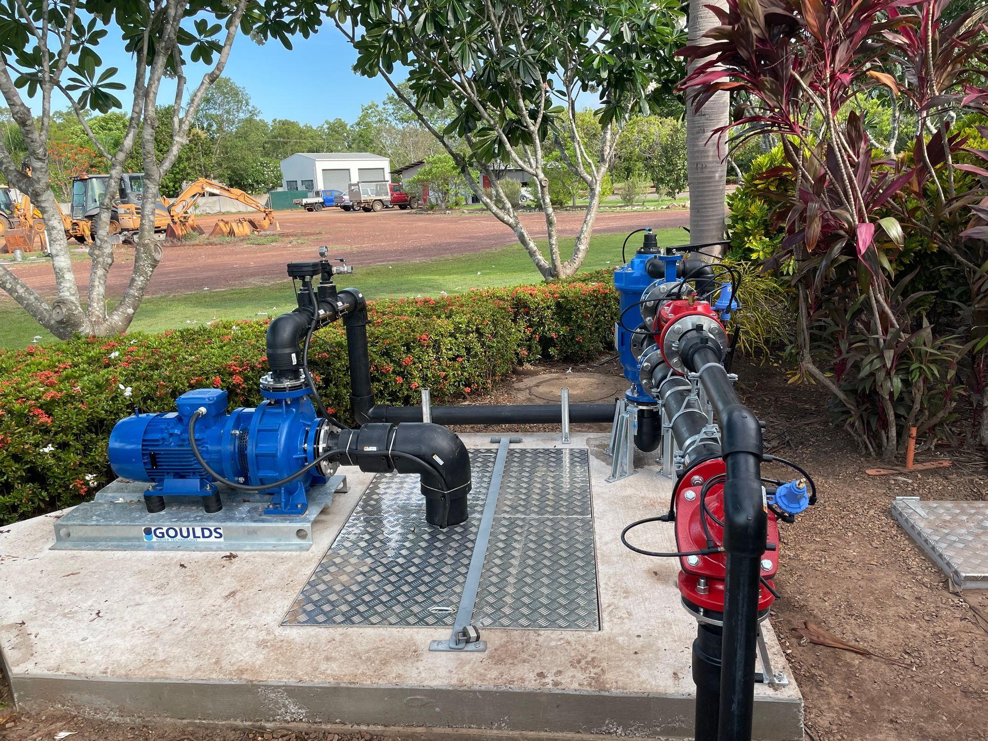 A blue pump is sitting on top of a concrete platform.
