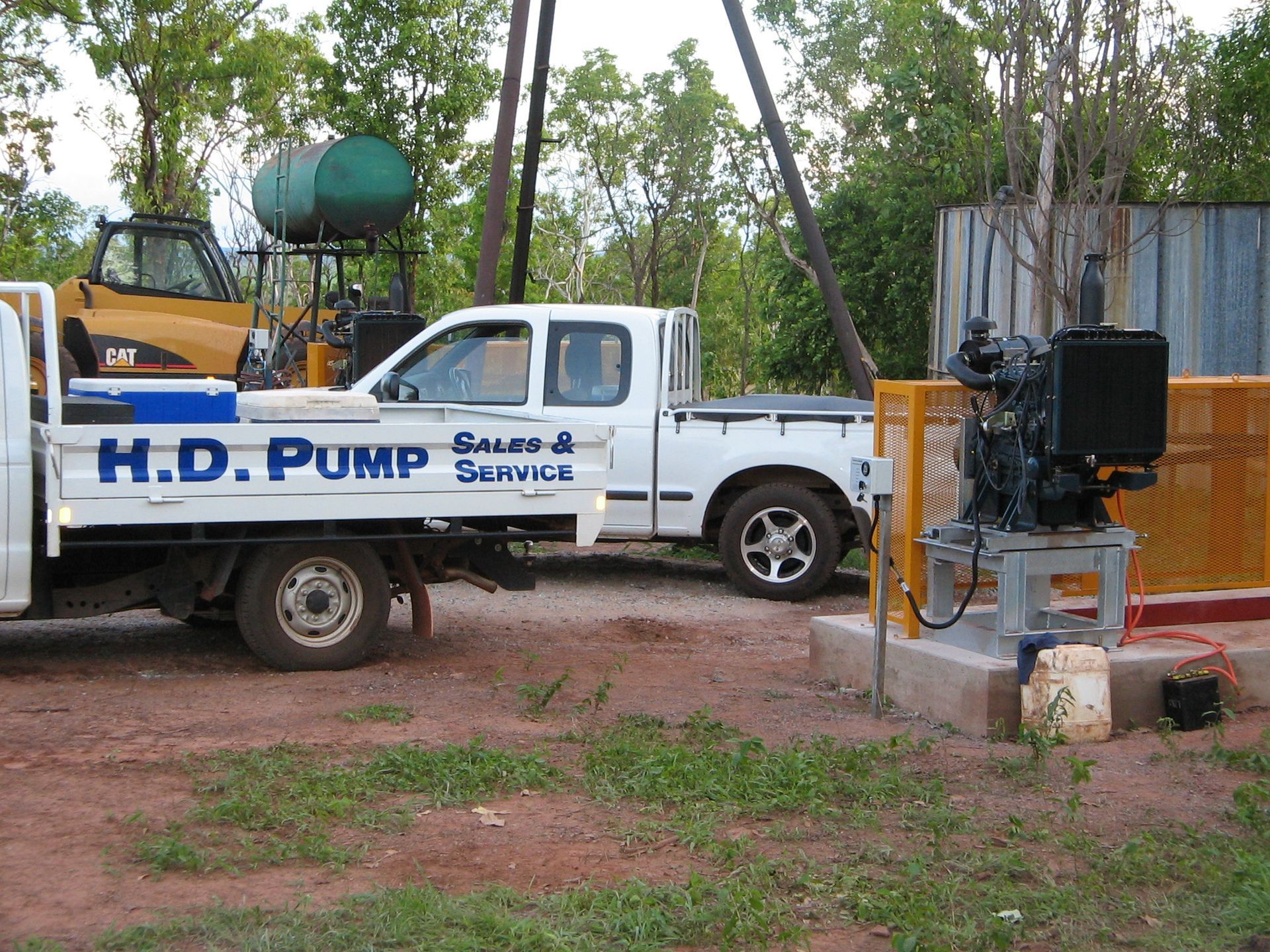 A h.d. pump truck is parked next to another truck