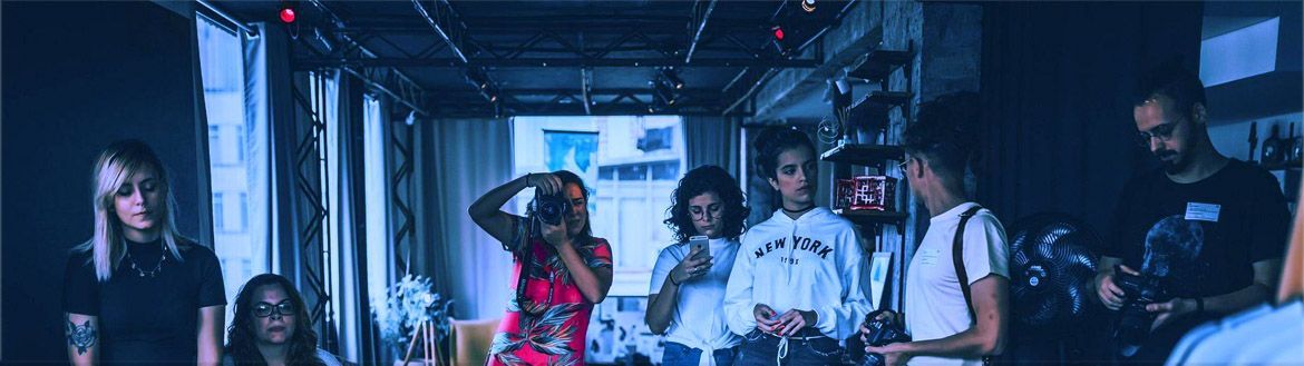 A group of hip young people at work in a photographer's studio.