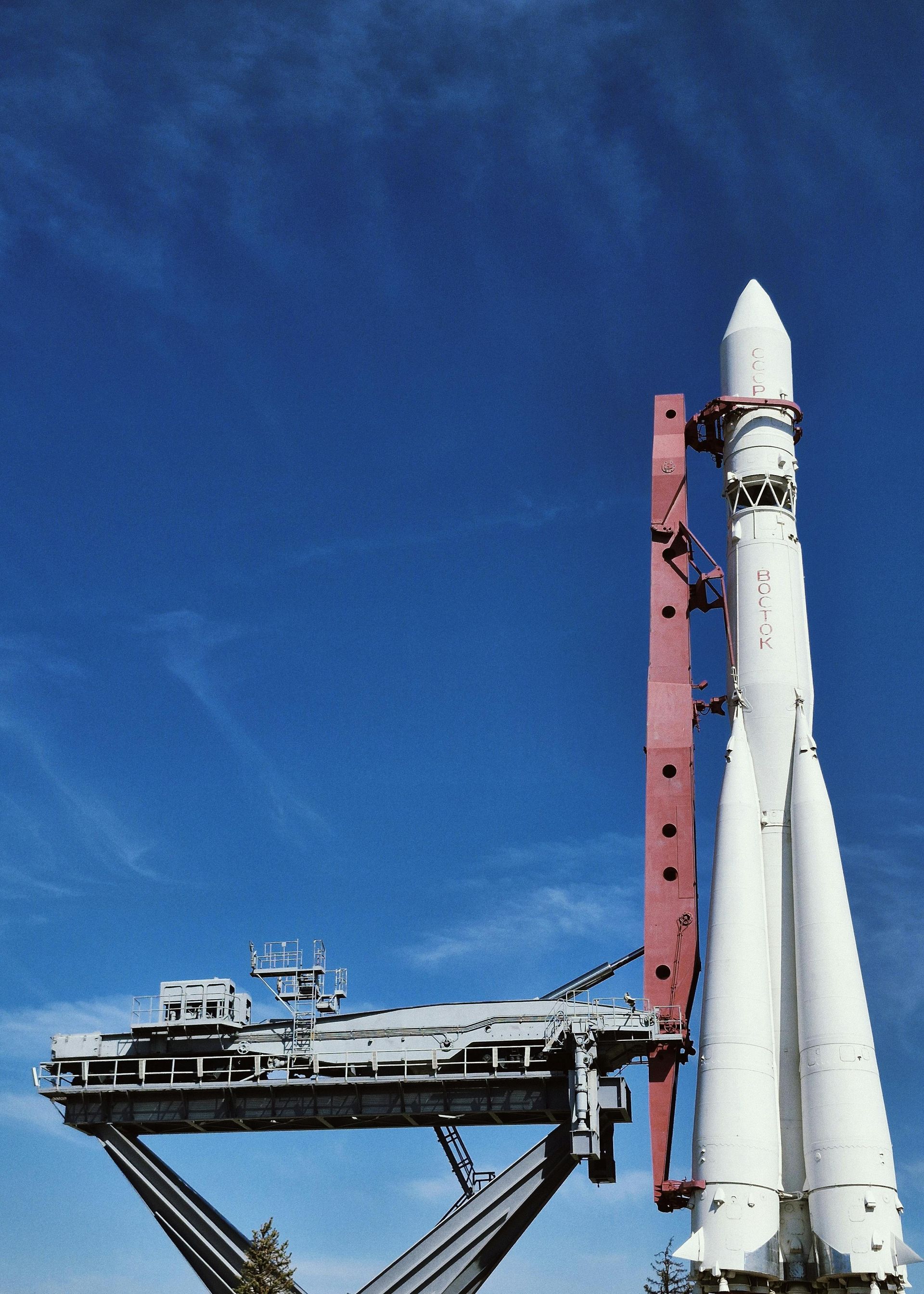 A large white rocket on the lauch pad.