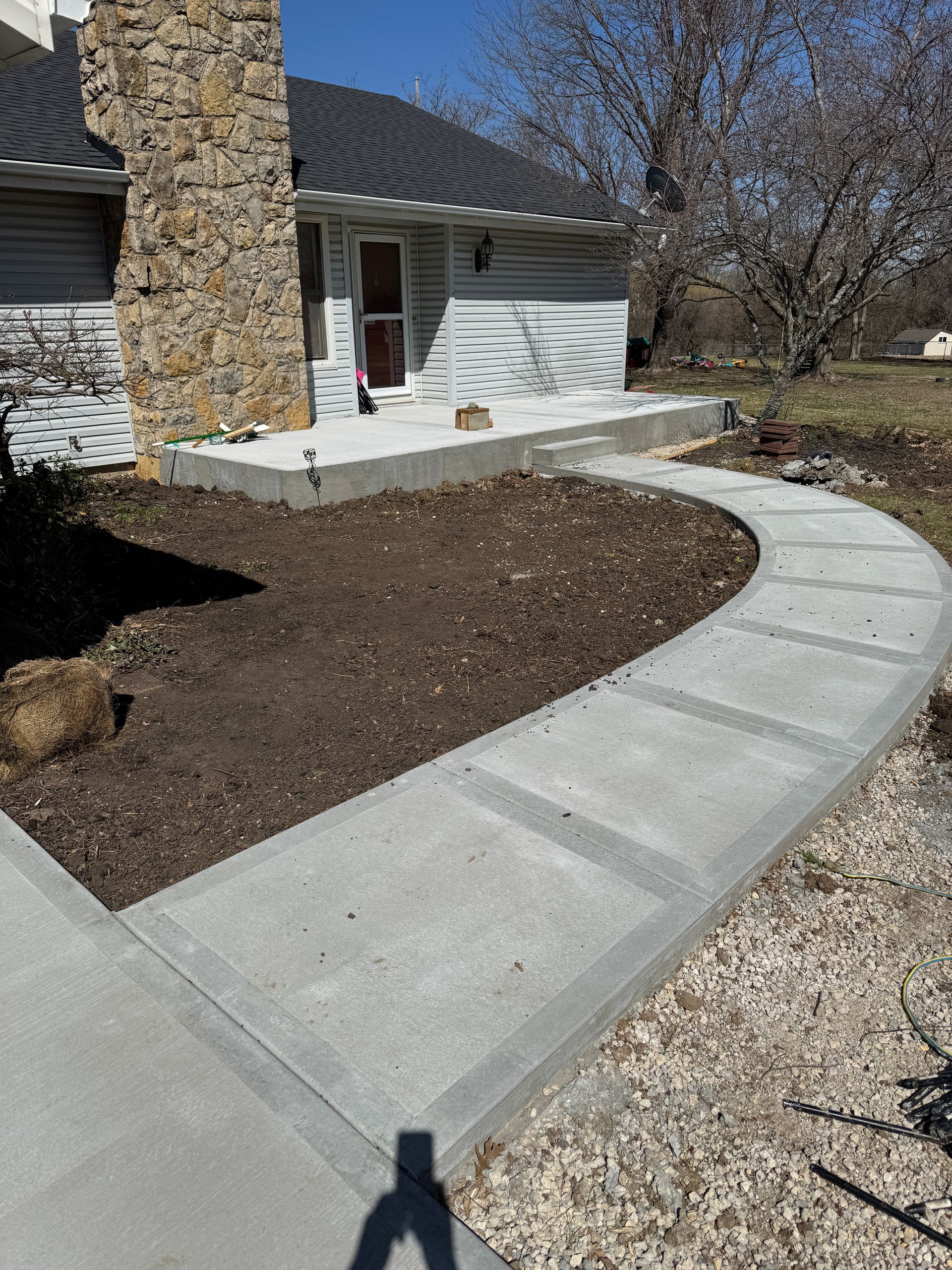 Playground with slides, climbing walls, and other equipment in a park, under construction.