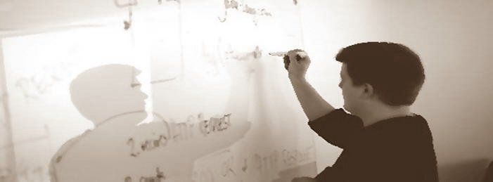 man writing on whiteboard