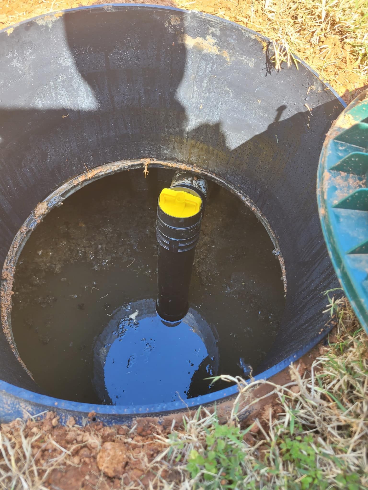 Open septic tank filled with water.