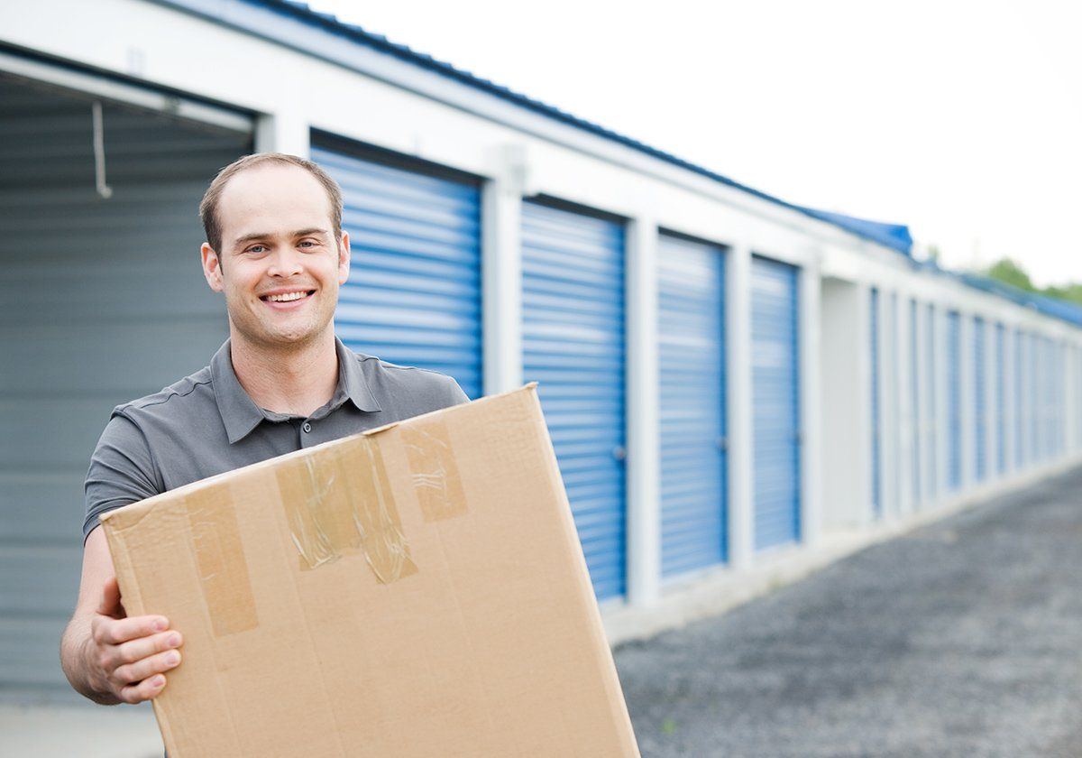 Man Holding A Box — Fairfield, CA — Cement Hill Storage Man Holding A Box — Fairfield, CA — Cement Hill Storage