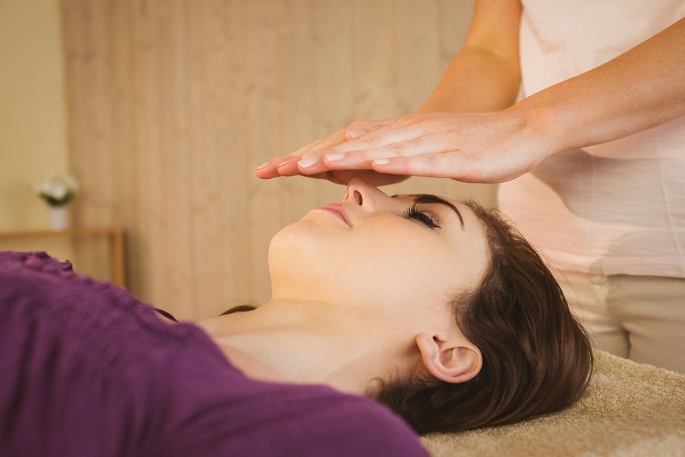 A Lady Receiving Reiki Therapy — Restorative Natural Therapies in The Entrance, NSW