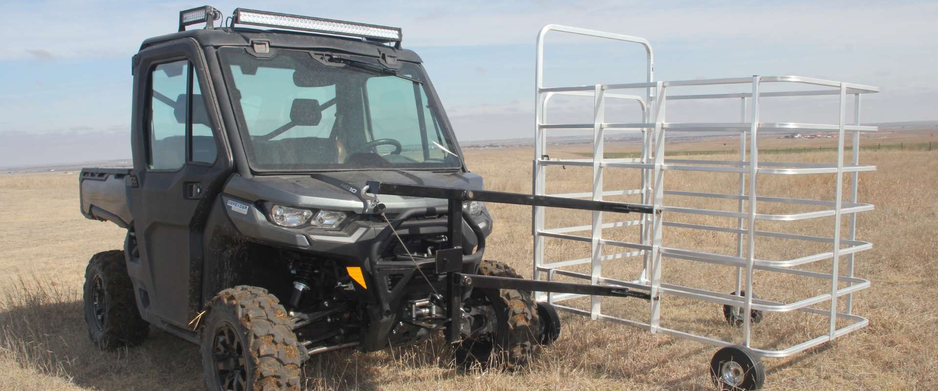 Hero shot of black utv with Fast Catch cage attached sitting in field