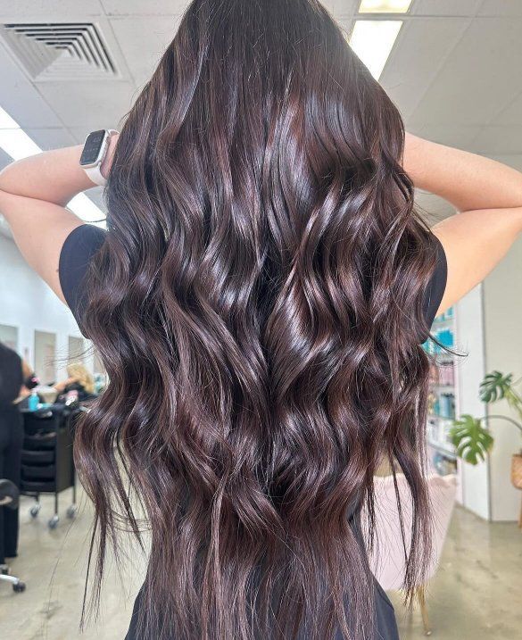 A Woman With Long Brown Hair Is Standing In A Salon — The Hair Boutique Co In Varsity Lakes, QLD