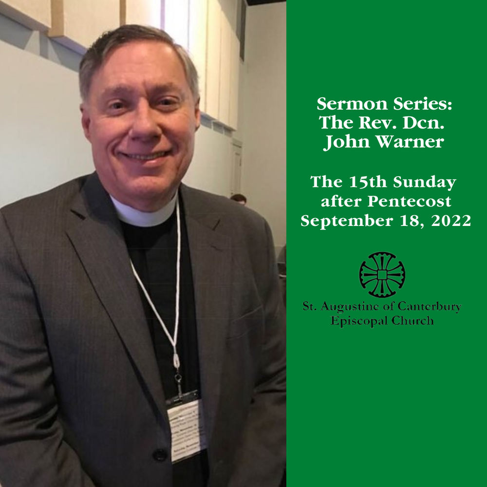 A man in a suit stands in front of a green sign that says sermon series the rev. den. john warner
