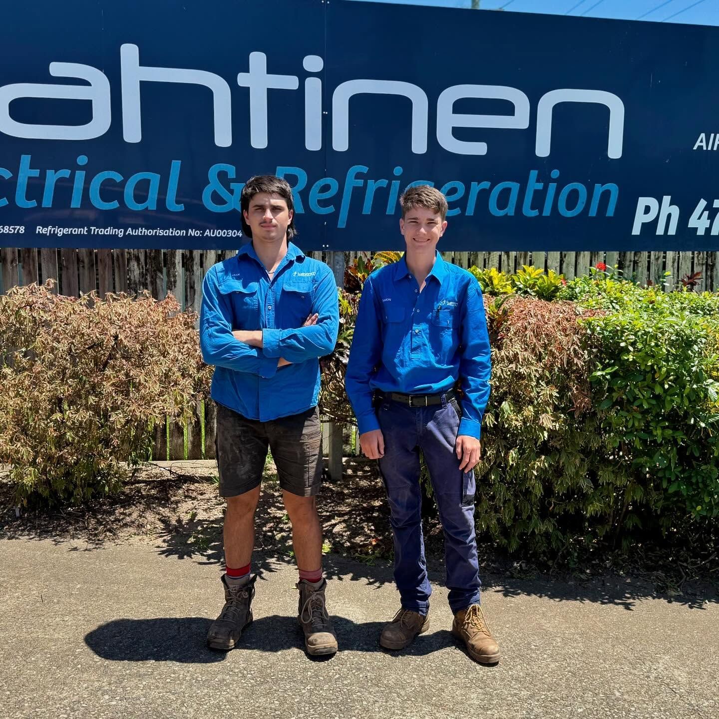 Two Men in Blue Work Shirts Stand in Front of an Electrical Business — Lahtinen Electrical & Refrigeration in Ingham, QLD