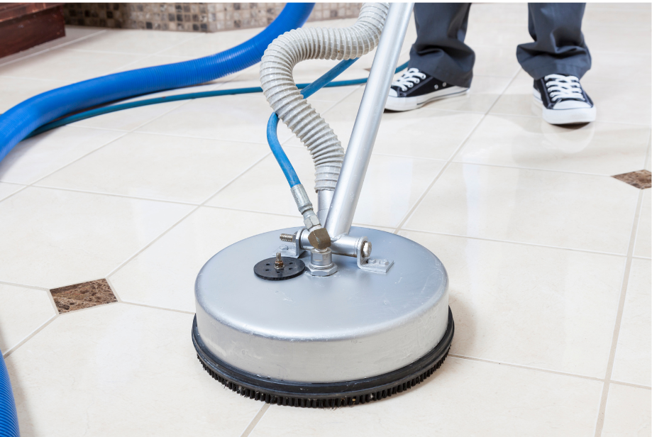 Schmitz employee using a professional tile scrubber to clean a client's tile and grout in Tucson, Arizona