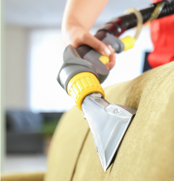 Schmitz employee using a professional upholstery tool to clean client's couch and remove stains in Tucson, Arizona