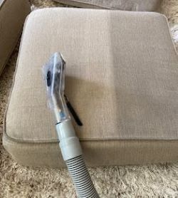 Schmitz employee uses extraction wand to clean dirty upholstery