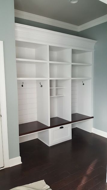 A room with a lot of shelves and benches in it.