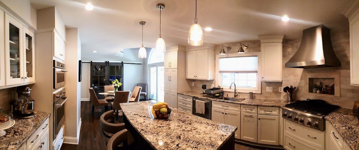 A kitchen with granite counter tops and stainless steel appliances.