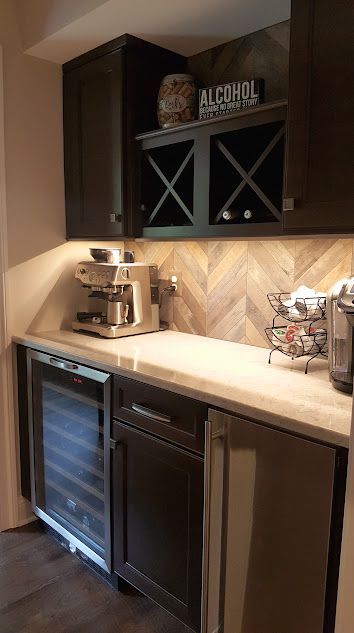 A kitchen with stainless steel appliances and a wine cooler.