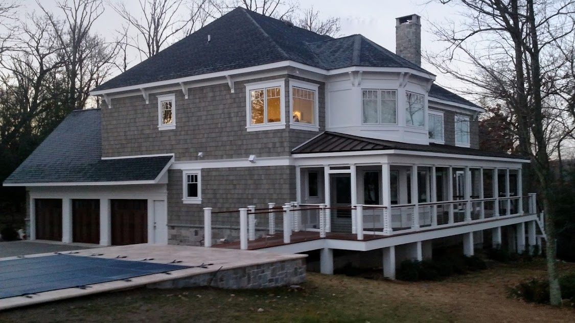A large house with a swimming pool in front of it