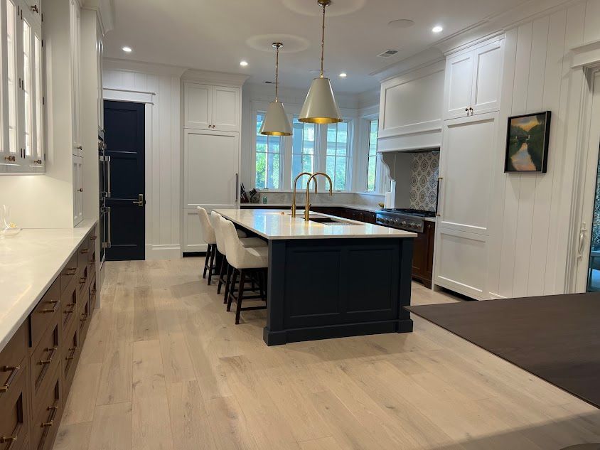 A kitchen with a large island in the middle of the room.