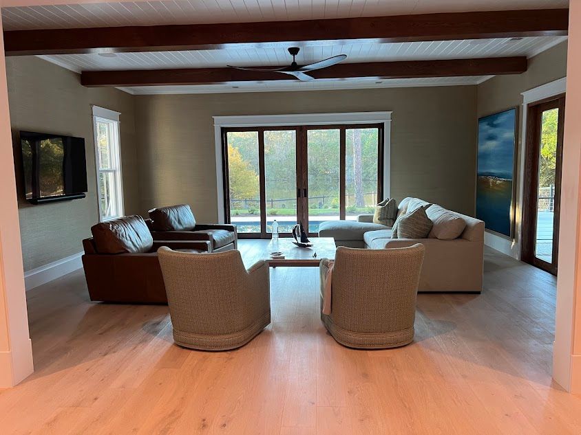 A living room with a lot of furniture and a ceiling fan