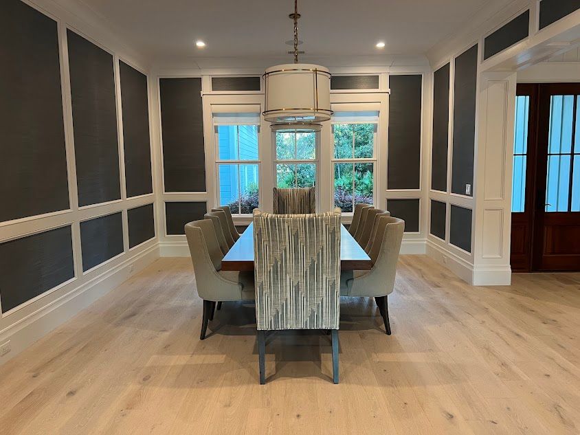 A dining room with a long table and chairs