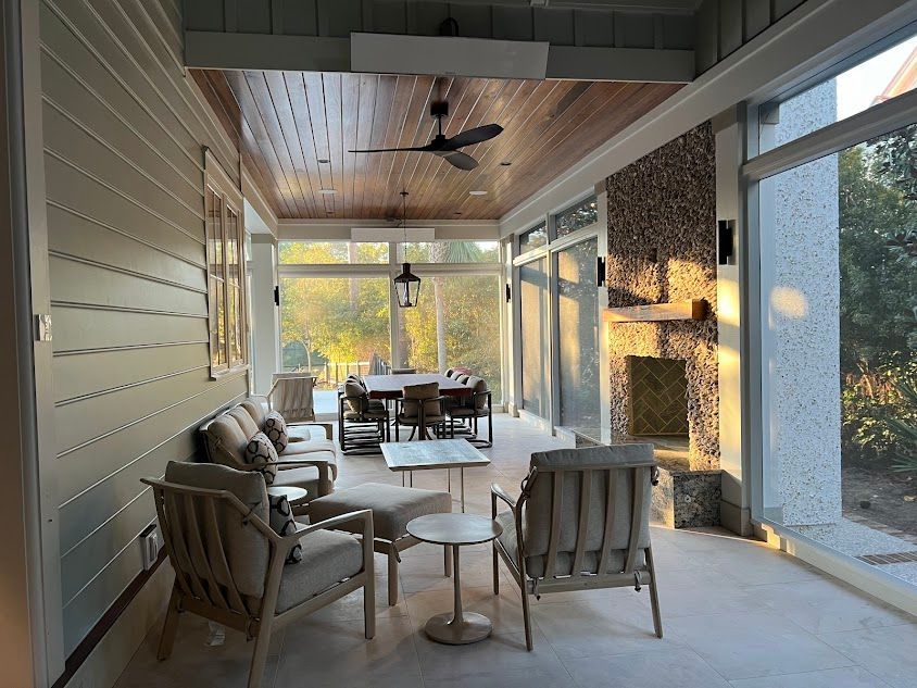 A living room with a table and chairs and a fireplace.