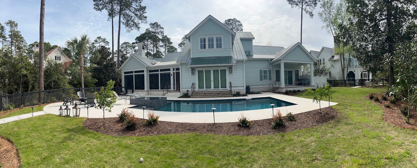 A large white house with a large swimming pool in the backyard.