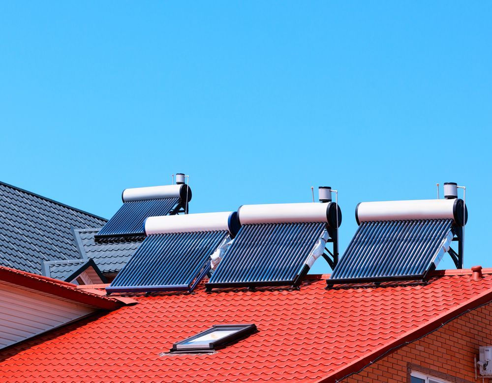 There Are Three Solar Panels on the Roof of a House — Beaumont Plumbing in Glenfield Park, NSW