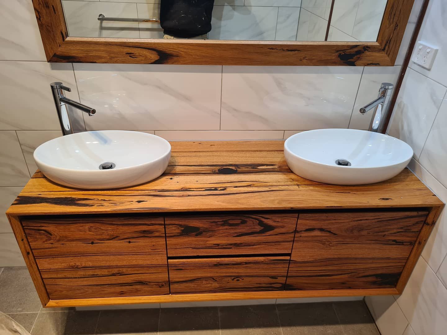 A Bathroom Vanity With Two Sinks and a Mirror — Beaumont Plumbing in Glenfield Park, NSW