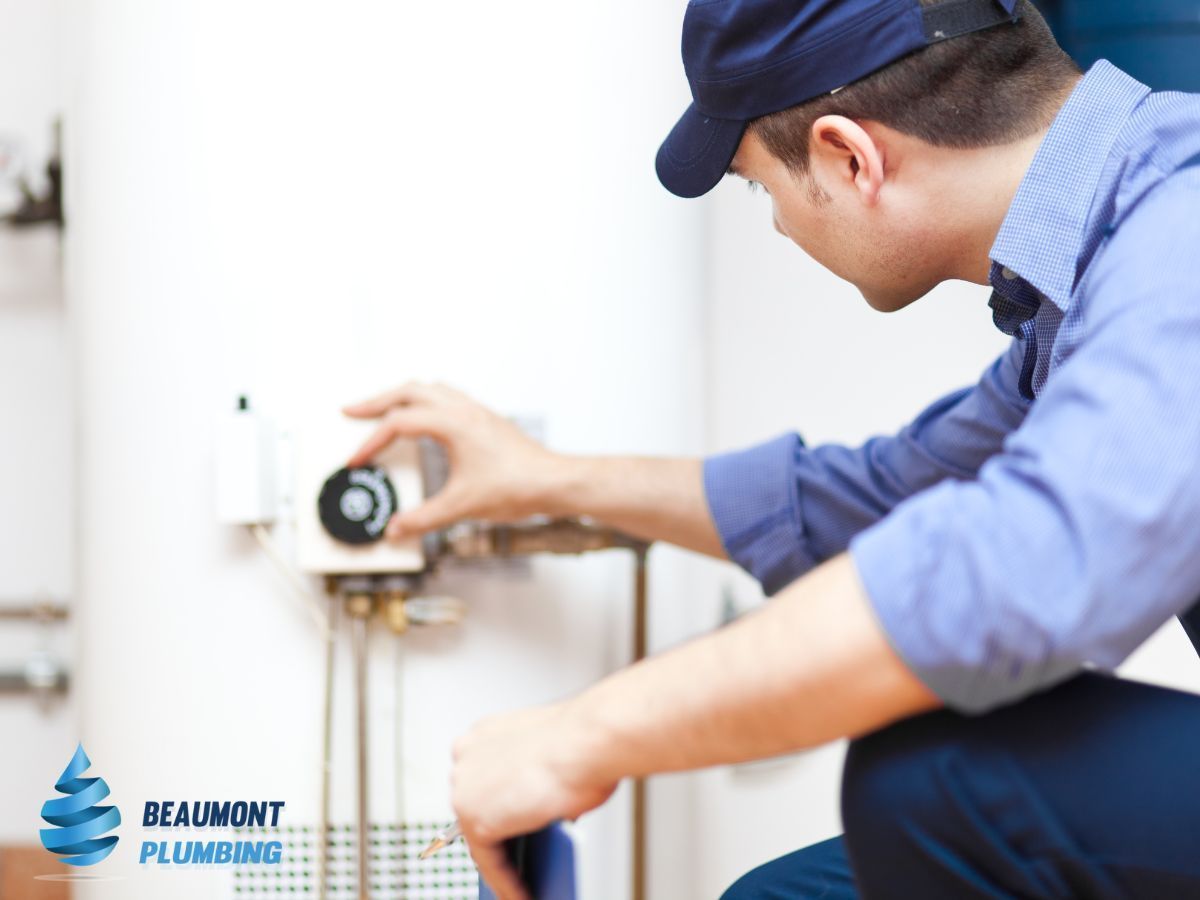 A Plumber is Working on a Water Heater in a Bathroom — Beaumont Plumbing in Glenfield Park, NSW