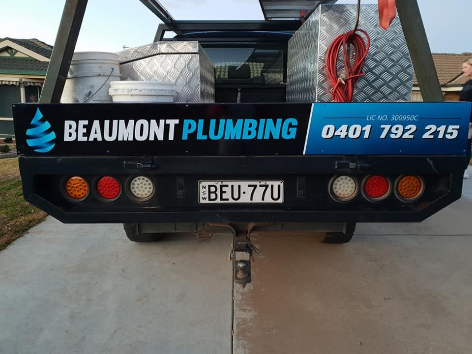 A Beaumont Plumbing Truck is Parked in a Driveway  — Beaumont Plumbing in Glenfield Park, NSW