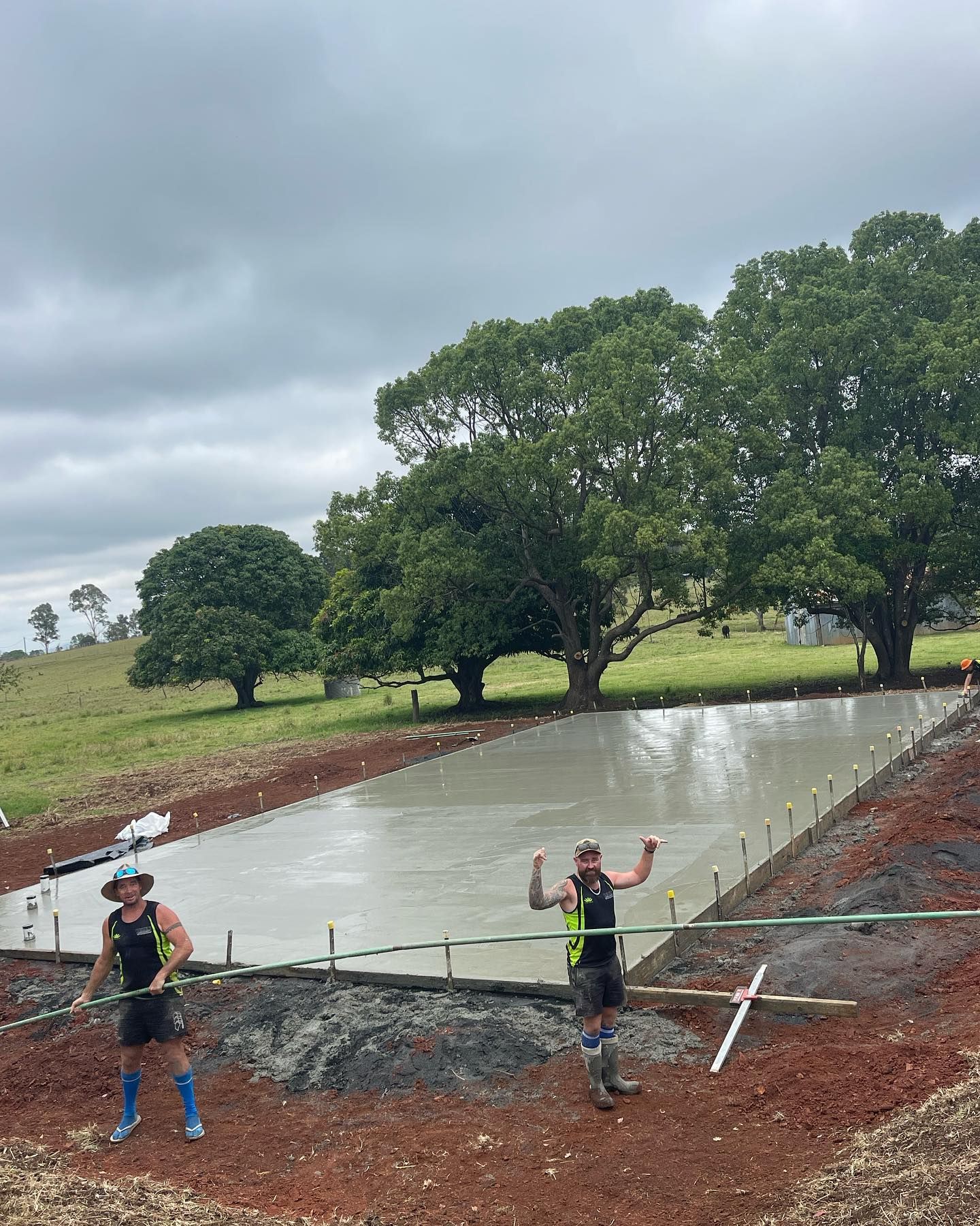 Two Men Standing on a Concrete Surface — Casino, NSW — Lismore Concrete Pumping