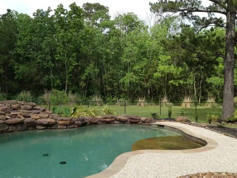 A large swimming pool with trees in the background