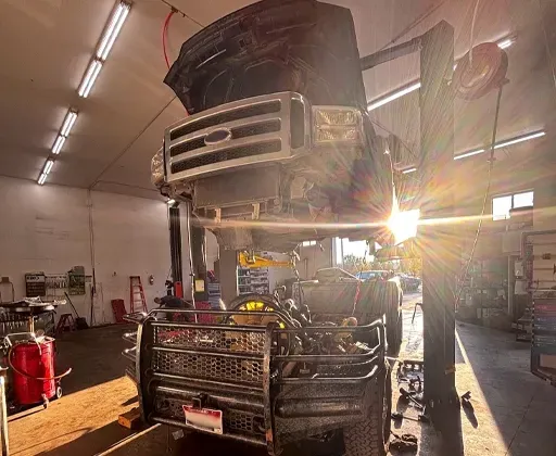F-350 Super Duty Truck parked in front of our shop with sign | Compass Mechanical Repair