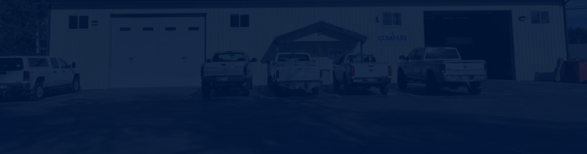 Trucks parked outside of our shop | Compass Mechanical Repair