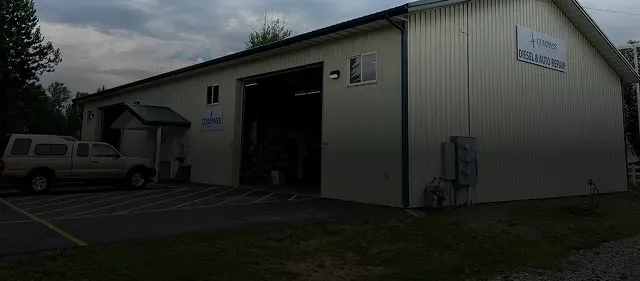 Our shop building with slight black background overlay | Compass Mechanical Repair