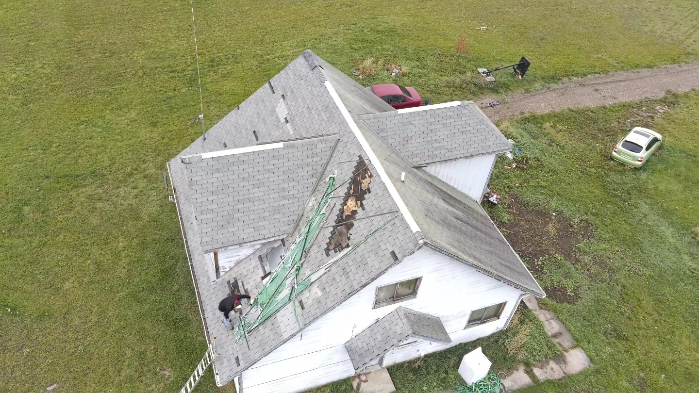 An aerial view of a house that has been damaged by a tornado.
