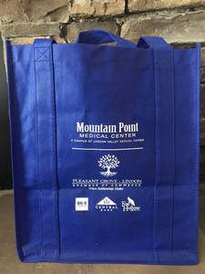 A blue tote bag for mountain point medical center is sitting on a table.