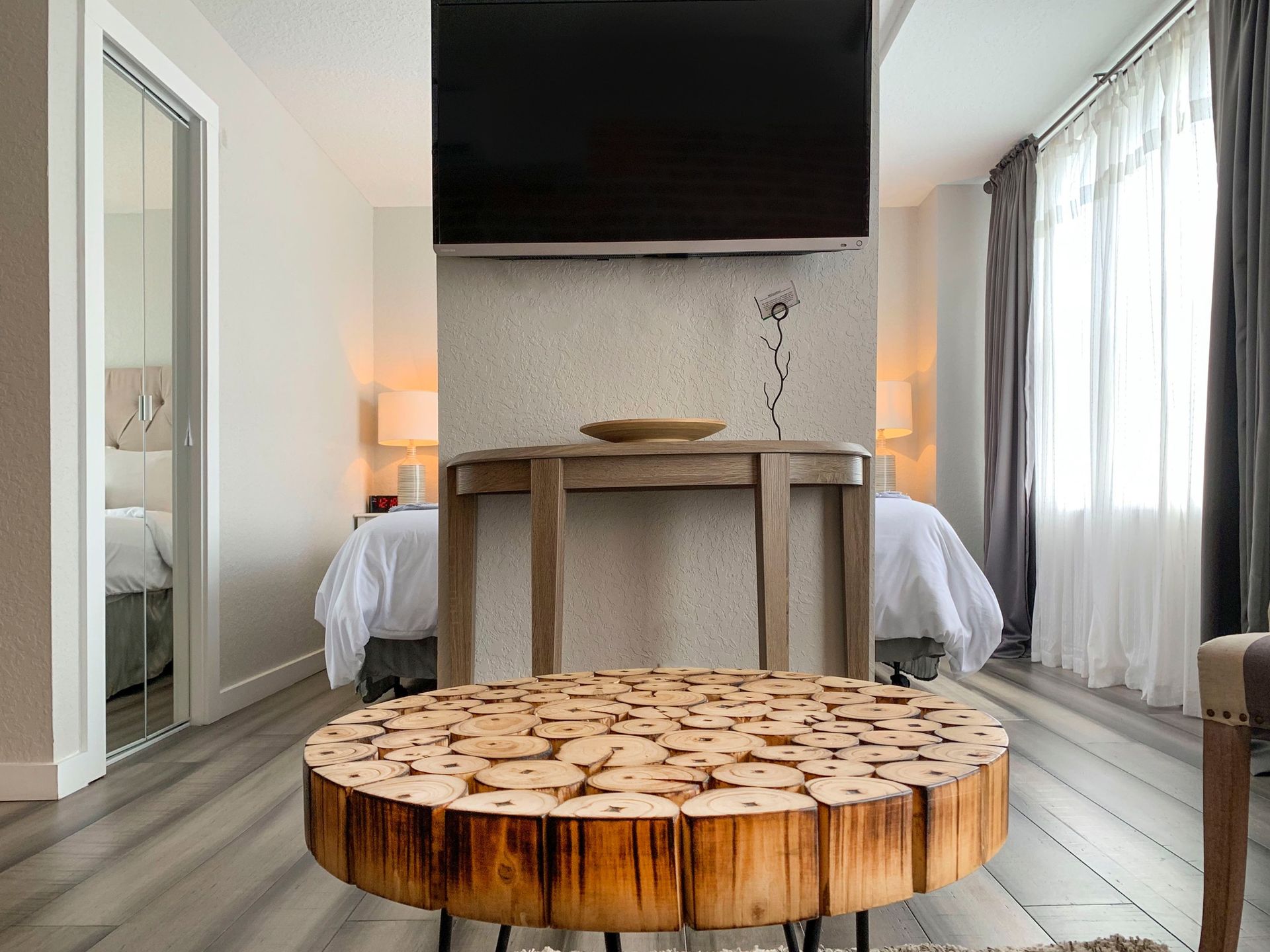 A living room with a wooden table and a flat screen tv.
