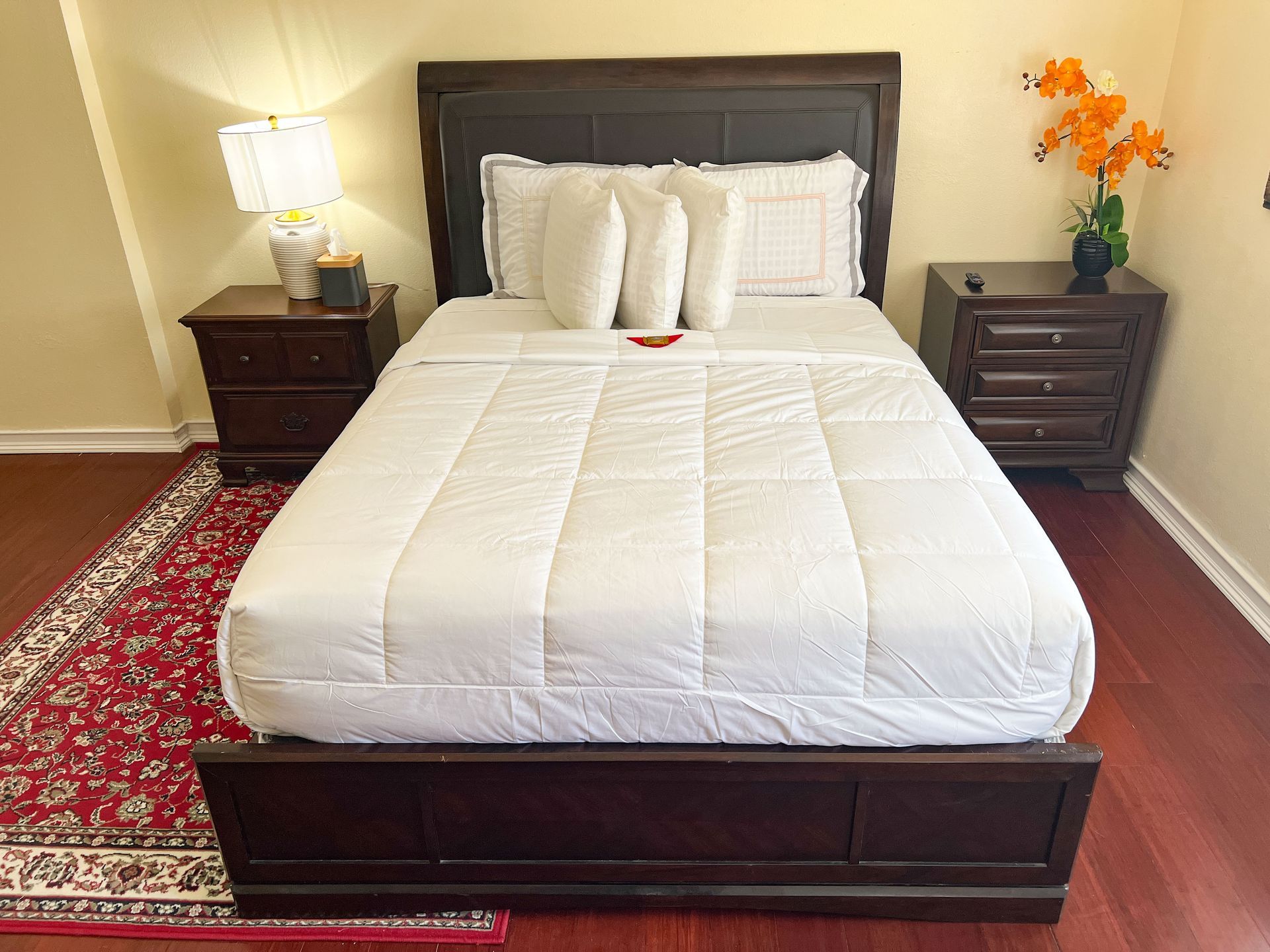 A bedroom with a bed and two nightstands